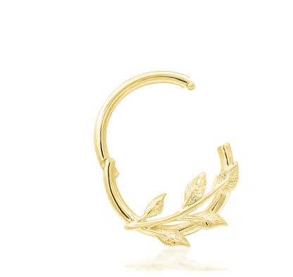 Nature-inspired septum ring in yellow gold with a sculpted gold branch following the curve of the hoop.