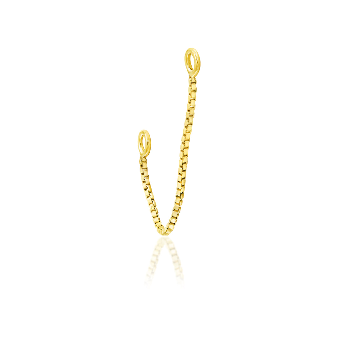     Solid yellow gold nose chain connecting a pair of healed nostril piercings
