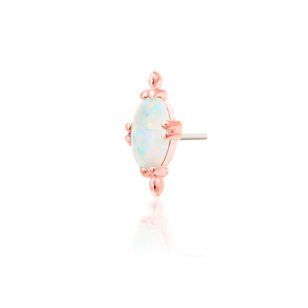 Rose gold conch earring featuring an oval white faux opal in a sculptural gold design
