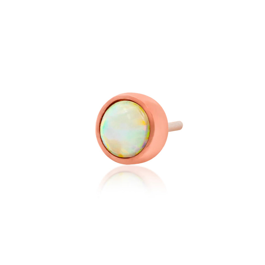 Petite rose gold tragus earring featuring a colourful synthetic opal