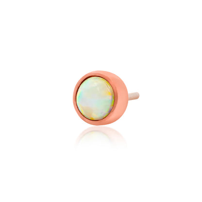 Petite rose gold tragus earring featuring a colourful synthetic opal