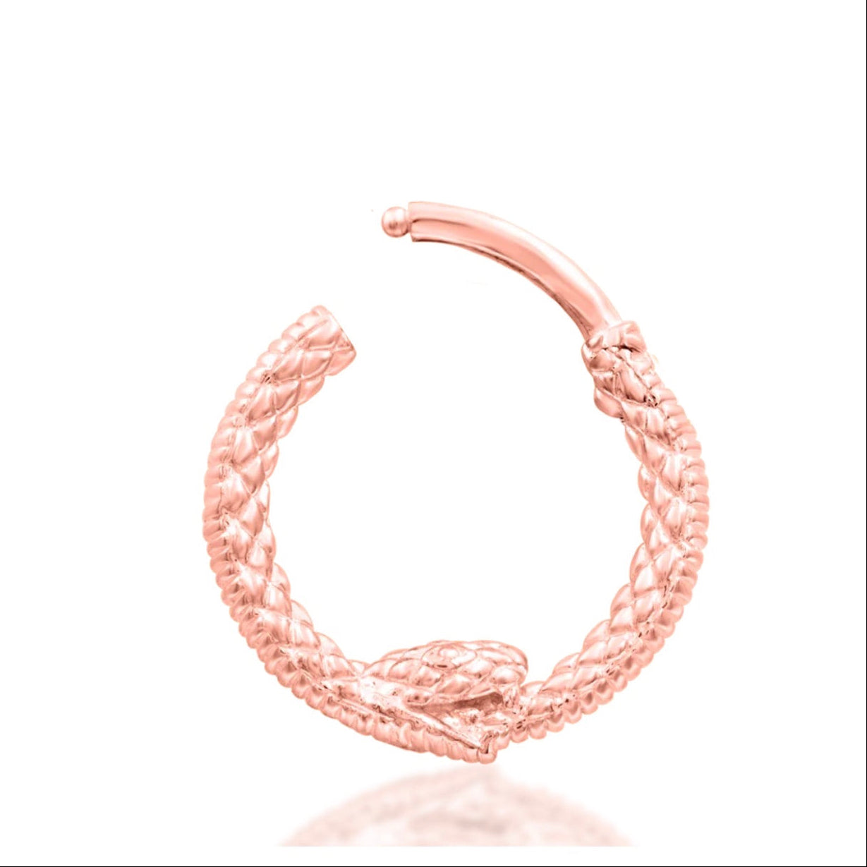 Serpent piercing jewellery in 14k rose gold, shown in Junipurr’s intricately detailed Ouroboros ring.