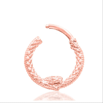 Serpent piercing jewellery in 14k rose gold, shown in Junipurr’s intricately detailed Ouroboros ring.