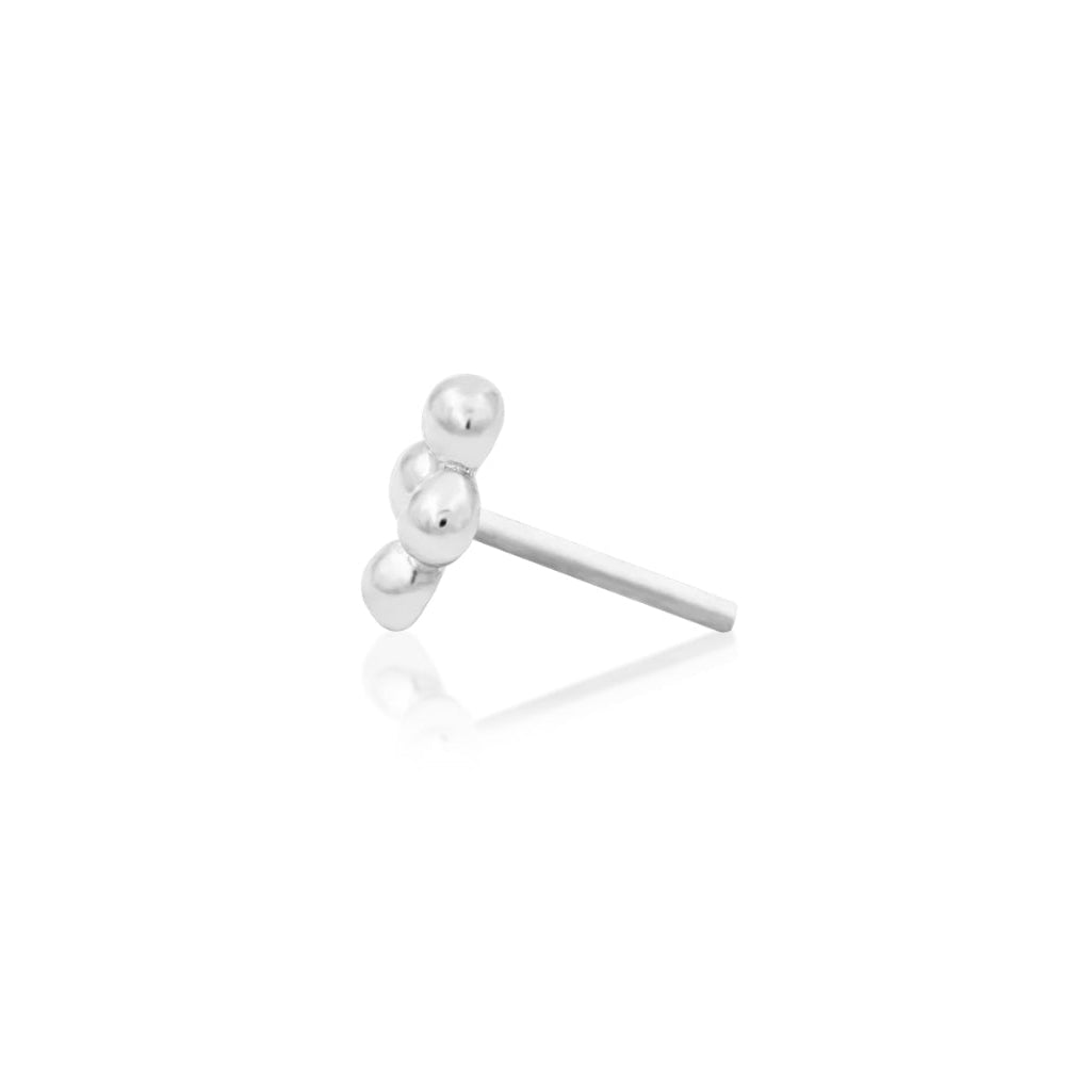 Small conch piercing earring in 14k white gold, with four polished beads arranged into a diamond silhouette.