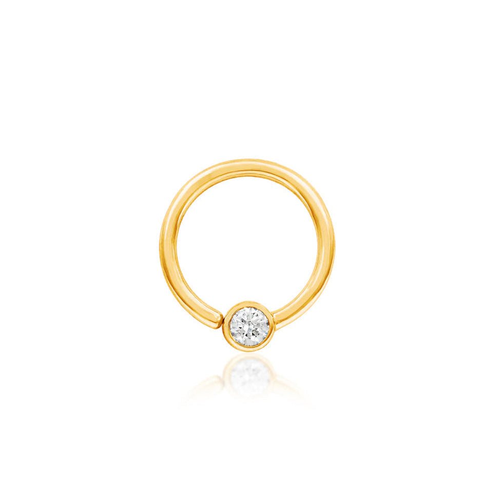 Solid gold CZ captive bead ring in 14k yellow gold featuring a fixed 3mm cubic zirconia.