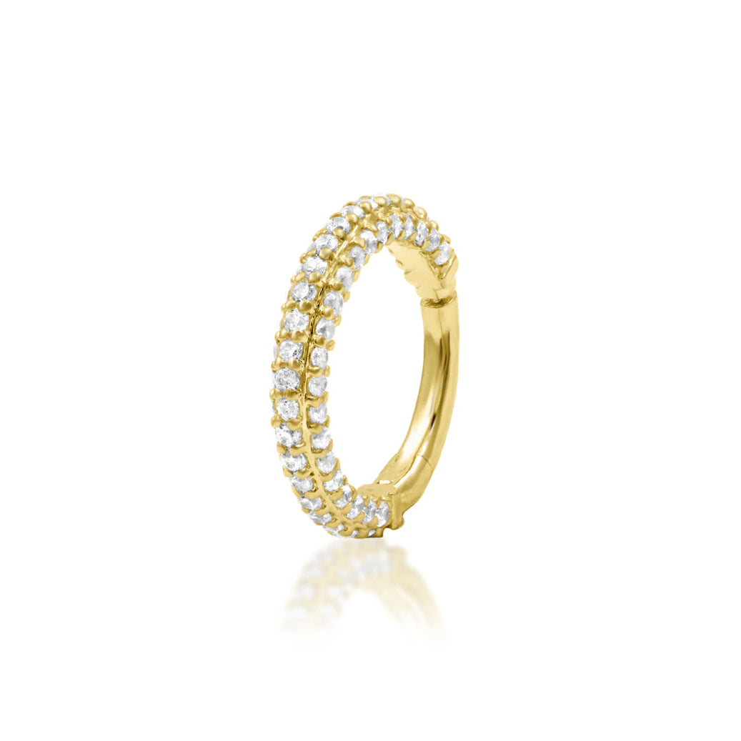 Solid gold pavé daith ring in 14k yellow gold featuring the continuous white cubic zirconia setting of Junipurr Demi.
