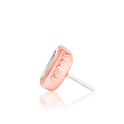 Threadless earring top in 14k rose gold with a baguette-cut cubic zirconia and decorative gold border.