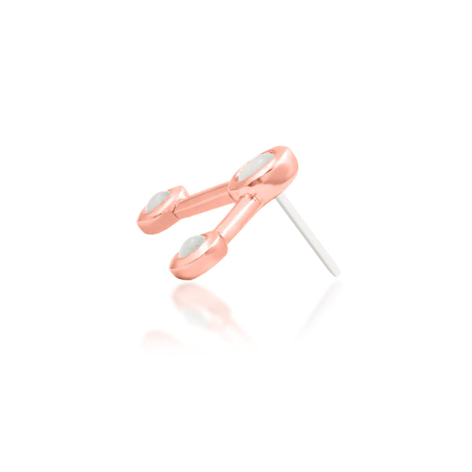Angled rose gold Asteria showing its linked circular gemstone composition