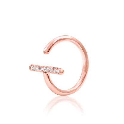 White CZ piercing jewellery in 14k rose gold, with nine small stones set into Junipurr Xaven.
