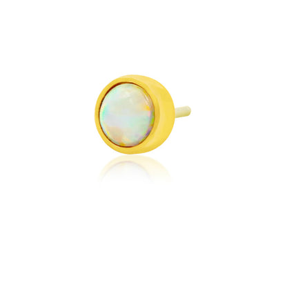Petite yellow gold tragus earring with a round synthetic opal