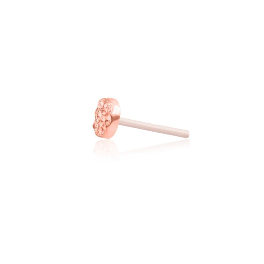 Minimal rose gold lobe piercing jewellery with a round hammered disc design