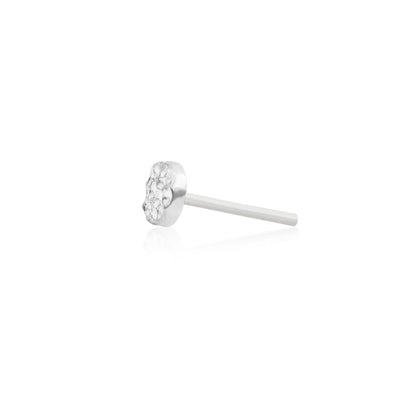 Minimal white gold flat piercing stud with a light-reflecting hammered surface
