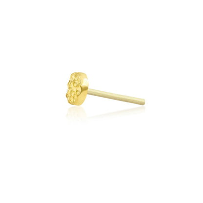 Tiny yellow gold tragus earring with a low-profile hammered disc design
